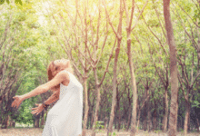 moteris mėgaujasi buvimu miške