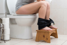 moteris demonstruoja kaip teisingai sėdėti ant tualeto