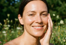 švytintis moters veidas iš arti pievoje